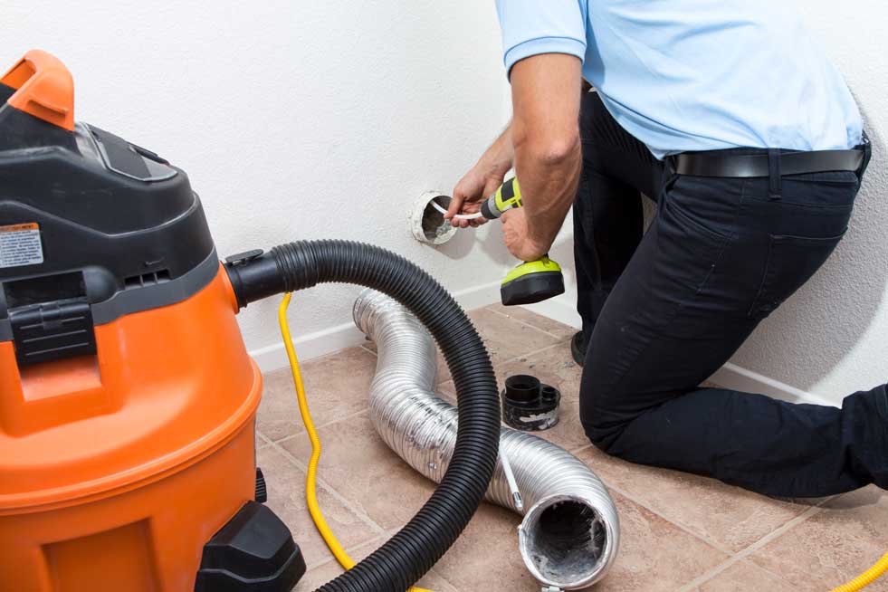 Man cleaning out a Dryer vent