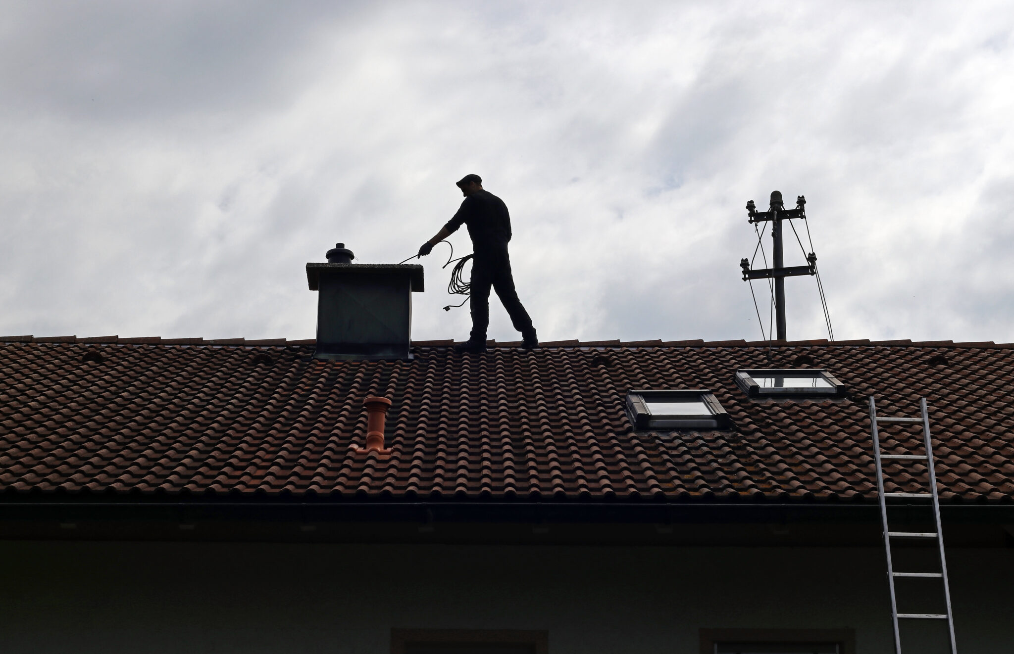 Chimney sweep cleans a chimney